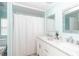 Bathroom features double sinks, and a framed mirror above the vanity at 8243 Pinetree Ln, Englewood, FL 34224