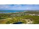 Breathtaking aerial view of the community surrounded by lush greenery, golf course, and stunning ocean views at 8937 Bantry Bay Blvd, Englewood, FL 34224