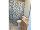 Cozy bathroom featuring a patterned shower curtain, providing a private and functional space at 8937 Bantry Bay Blvd, Englewood, FL 34224