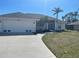 Charming home with a well-maintained lawn and a curved driveway leading to the garage at 8937 Bantry Bay Blvd, Englewood, FL 34224