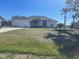 Inviting single-story home featuring a well-manicured lawn and a two-car garage at 8937 Bantry Bay Blvd, Englewood, FL 34224