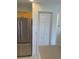 Bright kitchen featuring a stainless steel refrigerator and a closed pantry with bi-fold doors at 8937 Bantry Bay Blvd, Englewood, FL 34224