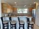 A kitchen with stainless steel appliances, wooden cabinets, and bar stool seating at 8937 Bantry Bay Blvd, Englewood, FL 34224