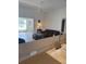 Spacious living room with large windows for natural light; view of the open concept kitchen at 8937 Bantry Bay Blvd, Englewood, FL 34224