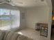 Comfortable living space featuring tile floors, a large window with views, and a cozy sofa at 8937 Bantry Bay Blvd, Englewood, FL 34224