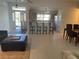 Open concept living space with a kitchen island and tile floors throughout at 8937 Bantry Bay Blvd, Englewood, FL 34224
