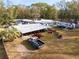 Property showcasing a collection of outbuildings, equipment, and vehicles in a rural setting at 9094 Preston Rd, Brooksville, FL 34601