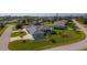 Extensive view shows the light blue home and the surrounding neighborhood at 9129 Bensonhurst Ln, Englewood, FL 34224