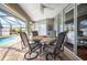 Inviting covered patio featuring a dining table and chairs, perfect for outdoor entertaining near pool at 9129 Bensonhurst Ln, Englewood, FL 34224