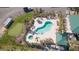 Aerial view of a pool and putting green with lounge chairs and well-kept landscaping at 9203 Griggs Rd # 301, Englewood, FL 34224