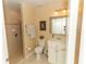 Bright bathroom with tiled shower, vanity with sink, and white fixtures at 9203 Griggs Rd # 301, Englewood, FL 34224
