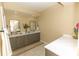 Bright bathroom featuring a double vanity with ample counter space and stylish decor at 9203 Griggs Rd # 301, Englewood, FL 34224
