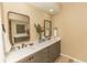 Spacious bathroom with double vanity, framed mirrors, granite counters, and decorative accents at 9203 Griggs Rd # 301, Englewood, FL 34224