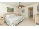 Cozy bedroom featuring a decorative ceiling fan, and a charming bed with floral-patterned comforter at 9203 Griggs Rd # 301, Englewood, FL 34224