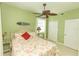 Cozy bedroom with beach theme decor, a ceiling fan, and bright, natural light at 9203 Griggs Rd # 301, Englewood, FL 34224