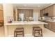 Well-lit kitchen boasts an expansive island with bar stool seating, stainless steel appliances, and stone countertops at 9203 Griggs Rd # 301, Englewood, FL 34224