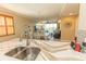 Open-concept kitchen offers stone counters, stainless appliances, and access to the dining and living areas at 9203 Griggs Rd # 301, Englewood, FL 34224