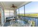 Relaxing screened lanai features scenic water views, comfortable seating, and a dining area at 9203 Griggs Rd # 301, Englewood, FL 34224