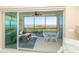 Inviting screened lanai offers comfortable seating, a dining area, and scenic water views at 9203 Griggs Rd # 301, Englewood, FL 34224