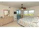 Serene bedroom with dresser and access to a private balcony showcasing waterfront views and a decorative ceiling fan at 9203 Griggs Rd # 301, Englewood, FL 34224