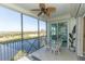 Enclosed porch featuring outdoor seating and beautiful views of the water and surrounding scenery at 9203 Griggs Rd # 301, Englewood, FL 34224