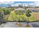 A tranquil backyard with a screened-in lanai, palm trees, and a pond view at 118 Albatross Rd, Rotonda West, FL 33947