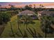 Aerial view of the backyard with a screened-in lanai and lush landscaping at 118 Albatross Rd, Rotonda West, FL 33947