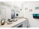 Bright bathroom with a neutral countertop, a large mirror, and cabinet storage at 118 Albatross Rd, Rotonda West, FL 33947