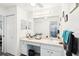 Bathroom with a neutral colored countertop, a large mirror, and double closets at 118 Albatross Rd, Rotonda West, FL 33947