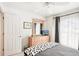 Cozy bedroom featuring a dresser, light gray bedding, and bright lighting at 118 Albatross Rd, Rotonda West, FL 33947