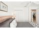 Bright bedroom featuring a ceiling fan, closet, and an ensuite bathroom door at 118 Albatross Rd, Rotonda West, FL 33947