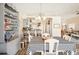 Bright dining room featuring a checkered tablecloth, chandelier, and an open view to the kitchen at 118 Albatross Rd, Rotonda West, FL 33947