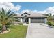 Charming single-story home featuring a well-manicured lawn and an attached two-car garage at 118 Albatross Rd, Rotonda West, FL 33947