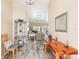 Open-concept view from the foyer into the living area with wood-look floors and neutral tones at 118 Albatross Rd, Rotonda West, FL 33947