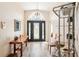 Inviting foyer featuring wood-look floors, decorative lighting and a beautiful front door at 118 Albatross Rd, Rotonda West, FL 33947