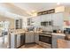 Charming kitchen featuring stainless steel appliances, a view to the dining area, and decorative backsplash at 118 Albatross Rd, Rotonda West, FL 33947