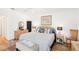 Main bedroom with a wicker bed frame, light walls, and a sitting bench at 118 Albatross Rd, Rotonda West, FL 33947