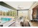 Screened-in patio dining area with an exterior view of the pool, trees, and the home at 118 Albatross Rd, Rotonda West, FL 33947