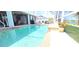 A beautiful swimming pool is surrounded by a screened-in patio with lake views at 118 Albatross Rd, Rotonda West, FL 33947