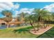 Tranquil water view showcasing lush backyard and tropical palm trees at 118 Albatross Rd, Rotonda West, FL 33947