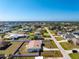 Aerial view of a beautiful single-story home and neighborhood, outlined in red, on a clear sunny day at 1313 Buereau Rd, Englewood, FL 34223