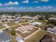 Aerial view of a single-story home and neighborhood, outlined in red, on a clear sunny day at 1313 Buereau Rd, Englewood, FL 34223