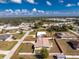 Aerial view of a beautiful single-story home and neighborhood, outlined in red, on a clear sunny day at 1313 Buereau Rd, Englewood, FL 34223