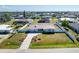 Aerial view of a charming fenced-in single-story home with beautiful landscaping and brick driveway at 1313 Buereau Rd, Englewood, FL 34223