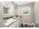 Bathroom vanity with double sinks, granite counters and wood-look flooring at 1313 Buereau Rd, Englewood, FL 34223