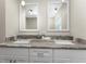 Modern bathroom vanity featuring granite countertop, double sinks, and pendant lighting at 1313 Buereau Rd, Englewood, FL 34223