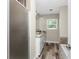 Bathroom featuring double sinks, granite countertops, and wood-look flooring at 1313 Buereau Rd, Englewood, FL 34223