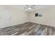 Neutral bedroom featuring a ceiling fan, closet and wood-look flooring at 1313 Buereau Rd, Englewood, FL 34223