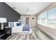 Bedroom featuring a dark accent wall, a barn door closet, and plenty of natural light from a window at 1313 Buereau Rd, Englewood, FL 34223