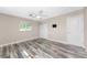 Bedroom featuring weathered wood flooring, closet, ceiling fan and mount for TV at 1313 Buereau Rd, Englewood, FL 34223